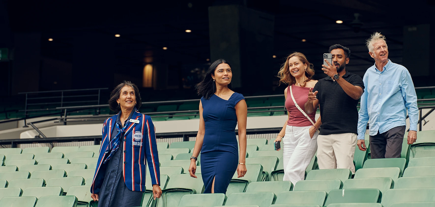 Four visitors look at MCG arena in awe on a tour