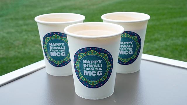Hot beverages with sticker that reads Happy Diwali from the MCG