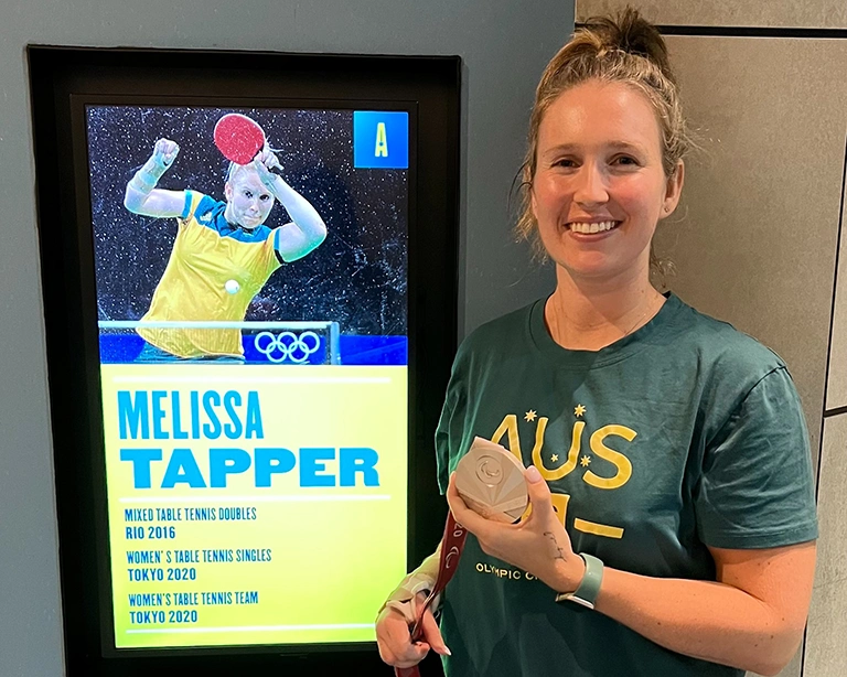 Olympian Melissa Tapper next to her display in the Australian Sports Museum