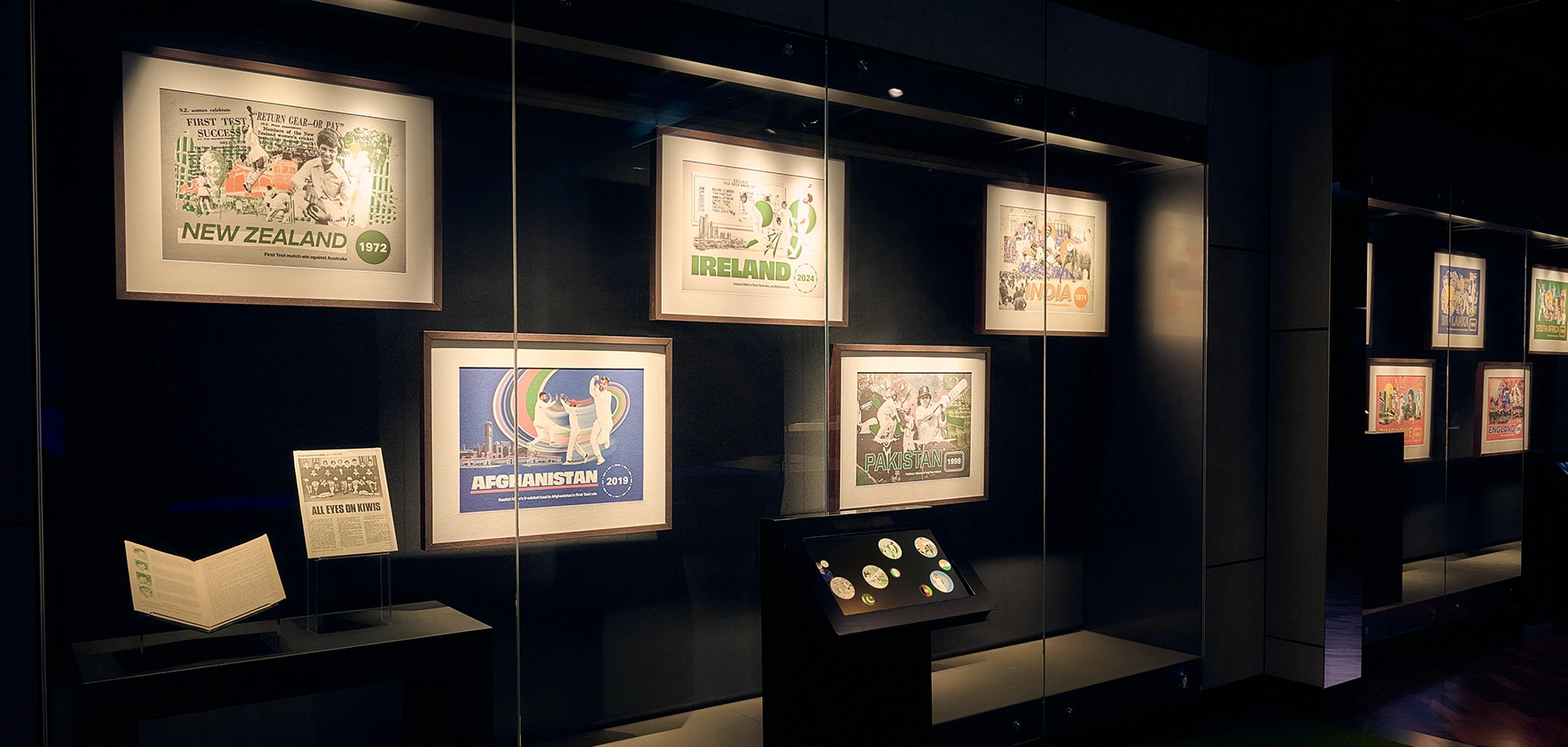 Framed Test nation posters, including New Zealand 1972, Ireland 2024 and Afghanistan 2019.