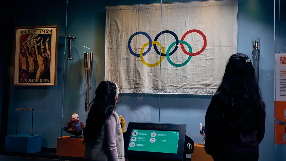 An Olympic flag and Paris 1924 Games poster on display