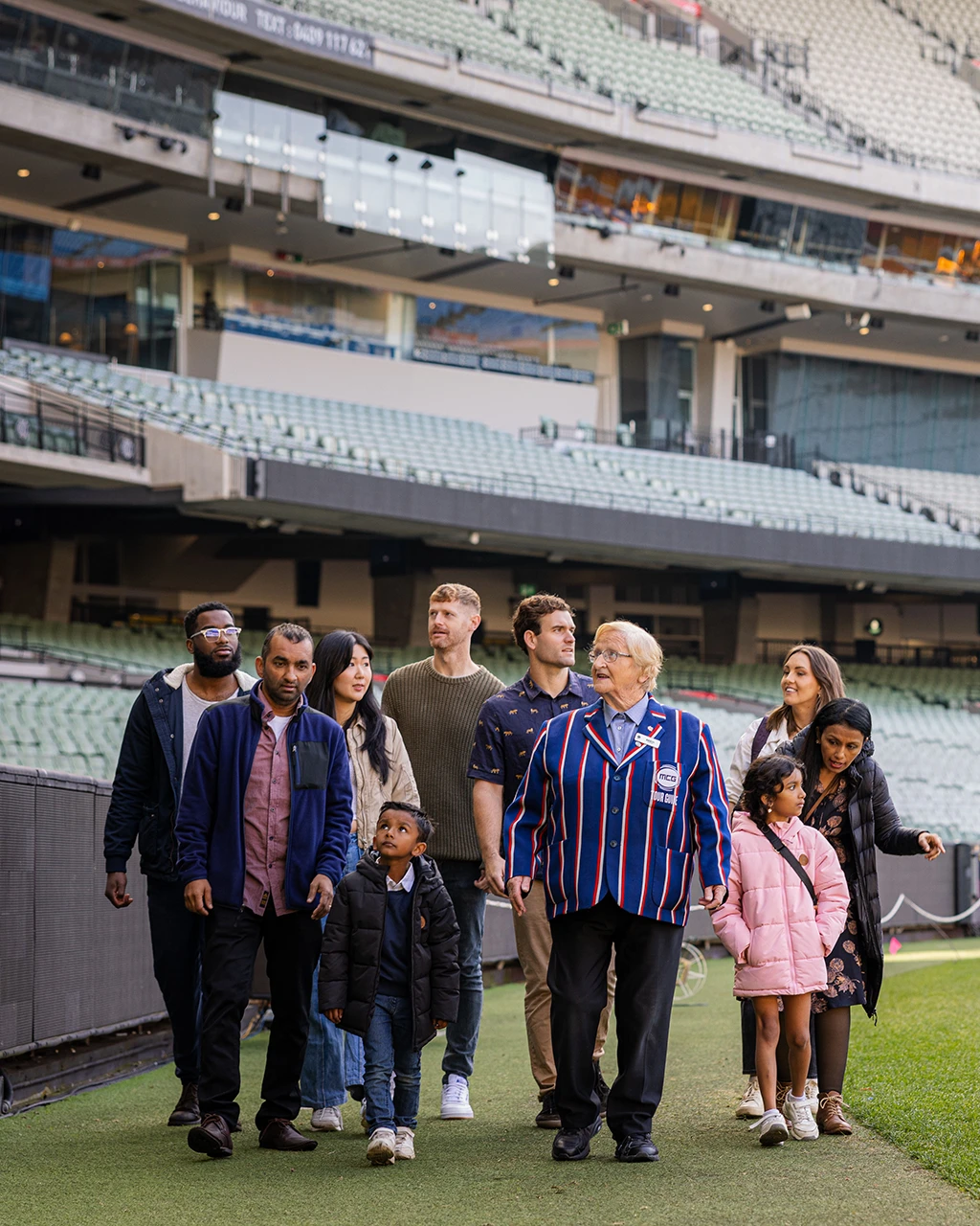 Tour group walks along MCG boundary line