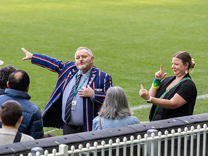 Auslan interpreter next to MCG Tour guide on the boundary line