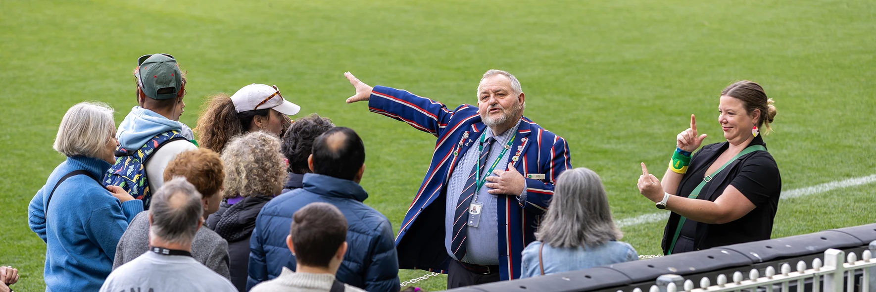 Auslan interpreter next to MCG Tour guide on the boundary line