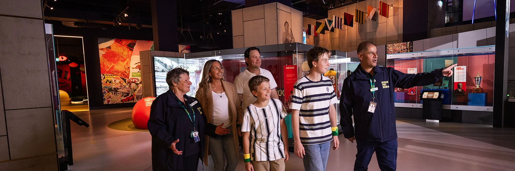Tour guide shows a group through the sports museum