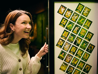 Visitor excitedly looks at cricket trading card display