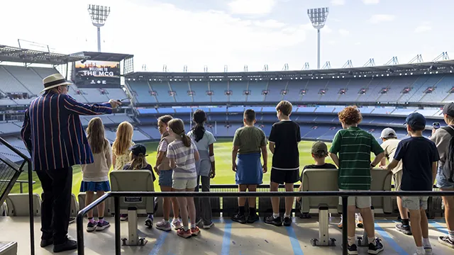 Children on a tour take in the view of the MCG from the top level. Stadium is empty.