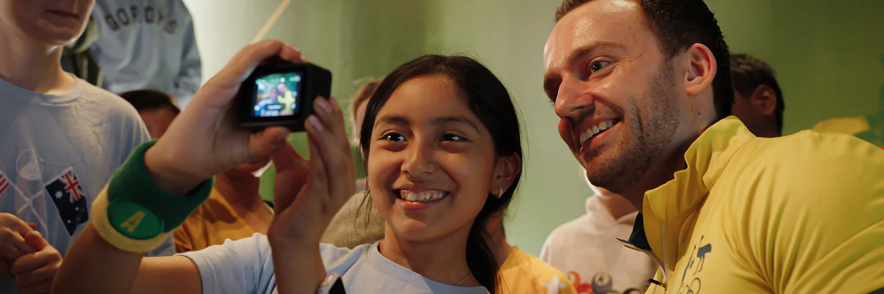 School group takes selfie photo with Olympian