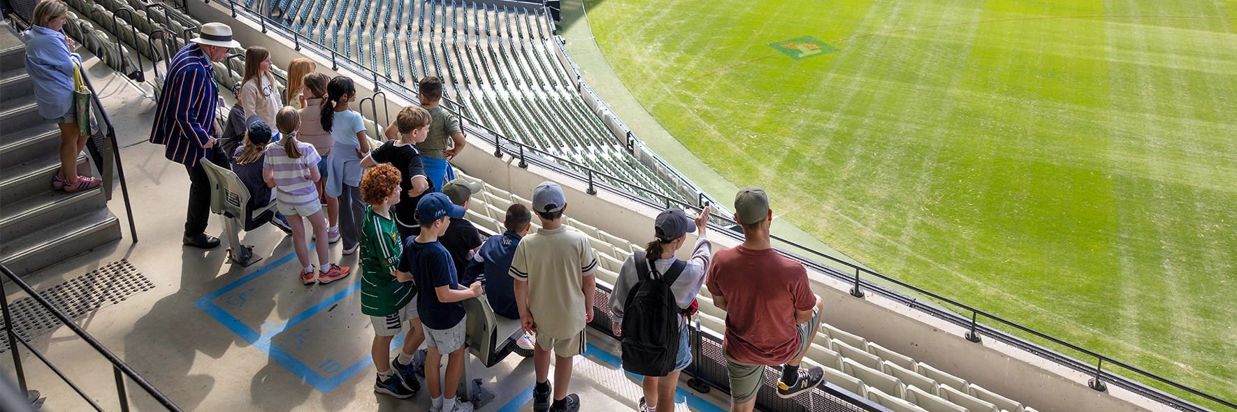 A group looks over the MCG arena from Level 4
