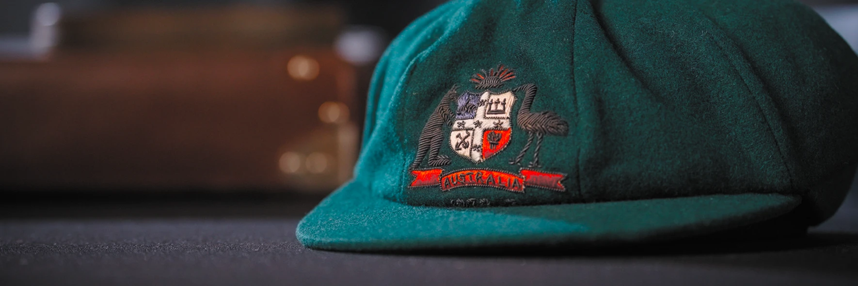 A Baggy Green hat sitting on a table under soft lighting