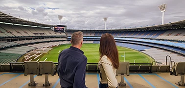 Two visitors overlook the MCG arena from an upper level