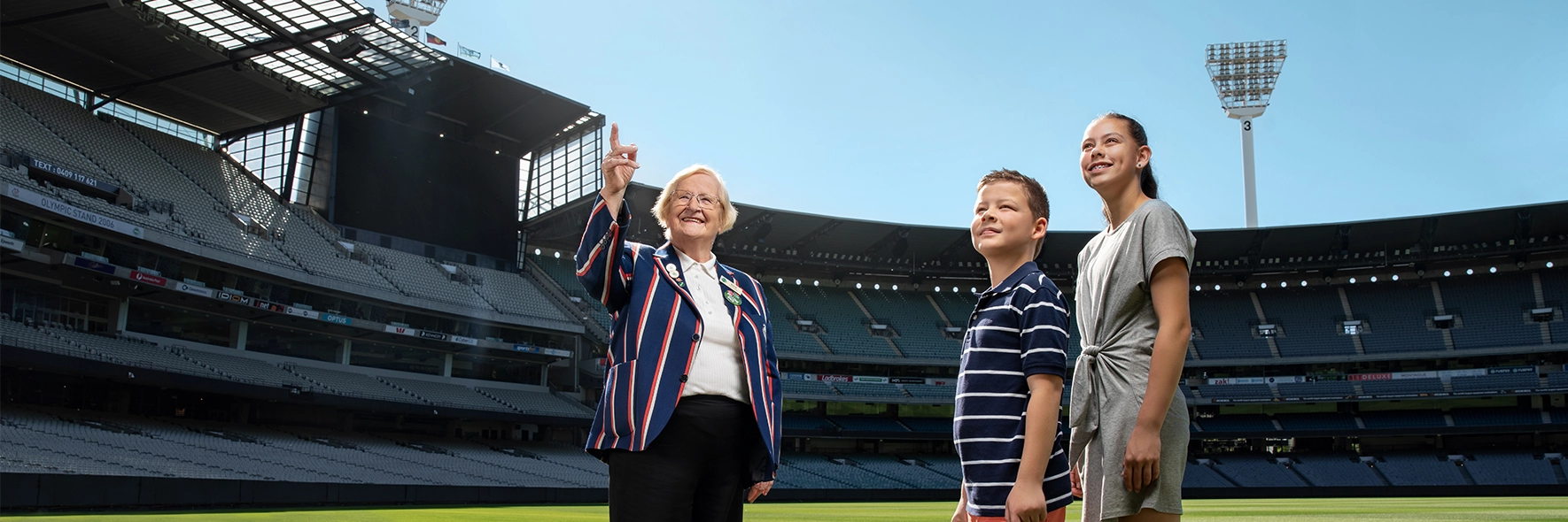 An MCG Tour Guide and two children on a Premium Access Tour