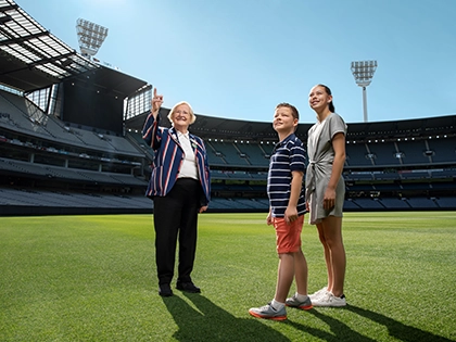 An MCG Tour Guide and two children on a Premium Access Tour