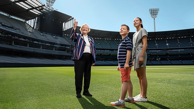 An MCG Tour Guide and two children on a Premium Access Tour
