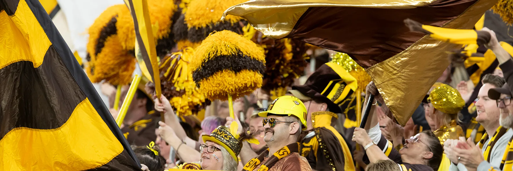 Hawthorn fans celebrate in the cheer squad area at the MCG