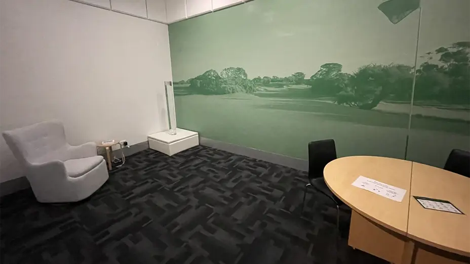 Room with comfortable chair, and table and chairs.