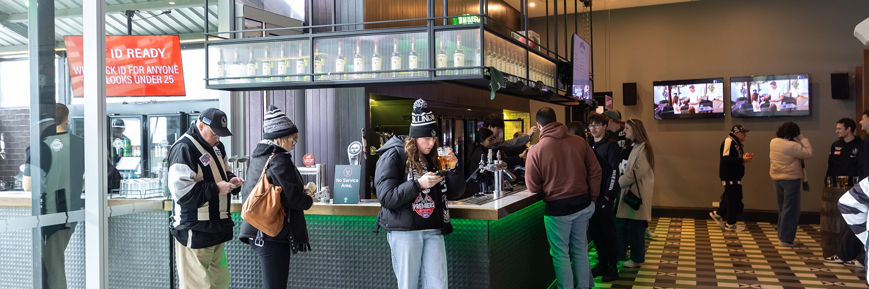 Fans stand at the indoor bar at The Outer Bar at the MCG