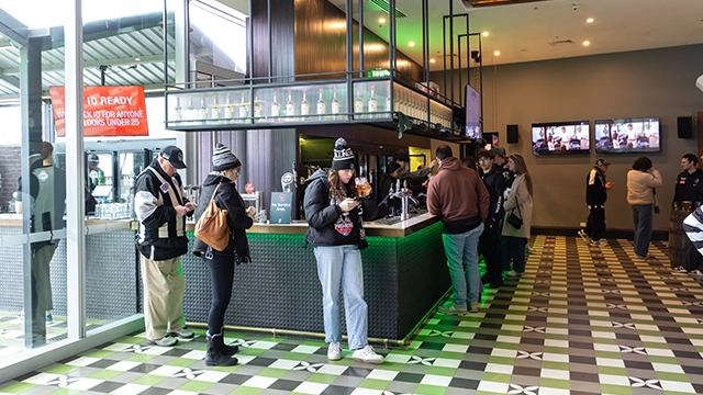 Fans stand at the indoor bar at The Outer Bar at the MCG
