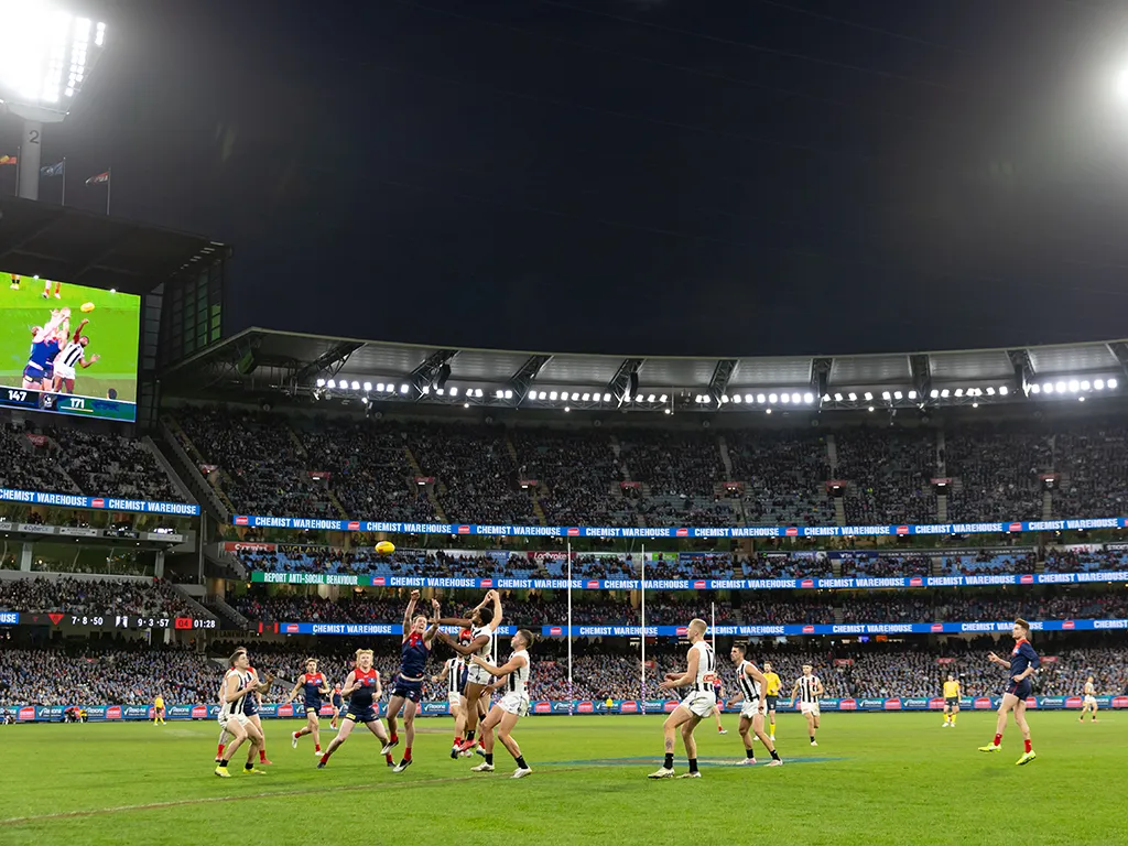 Melbourne and Collingwood play AFL under lights at the MCG