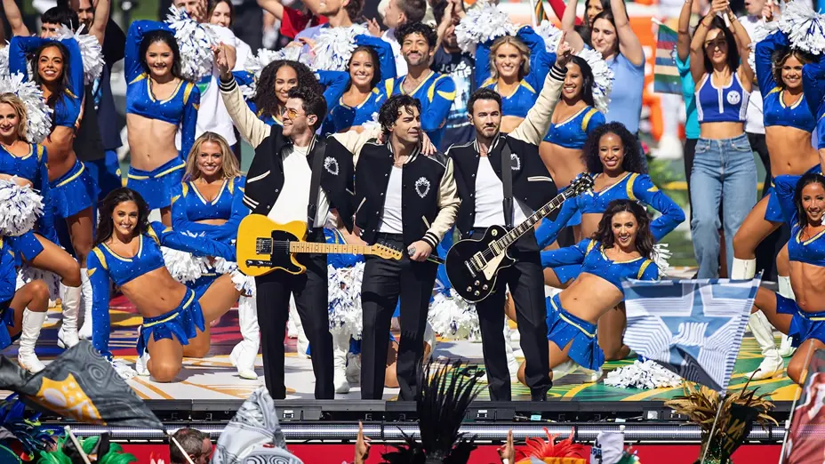 The Jonas Brothers performing on field with LA Rams cheerleaders at the MCG