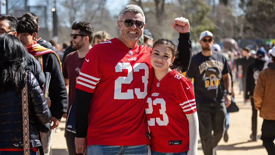 Fans in matching 49ers number 23 jerseys outside the MCG