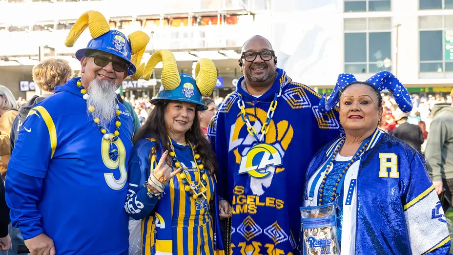 Four LA Rams fans in team colours and ram horn hats outside the MCG