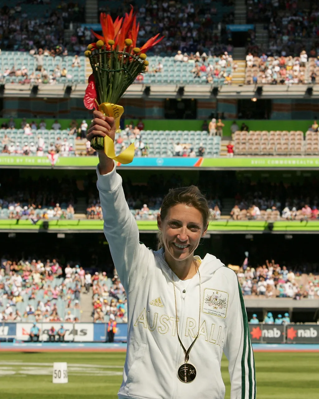 Kerryn McCann of Australia poses with a gold medal during the medal ceremony at the MCG.
