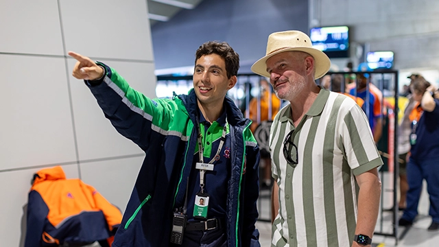 An MCG staff member provides directions for a patron on an MCG game day