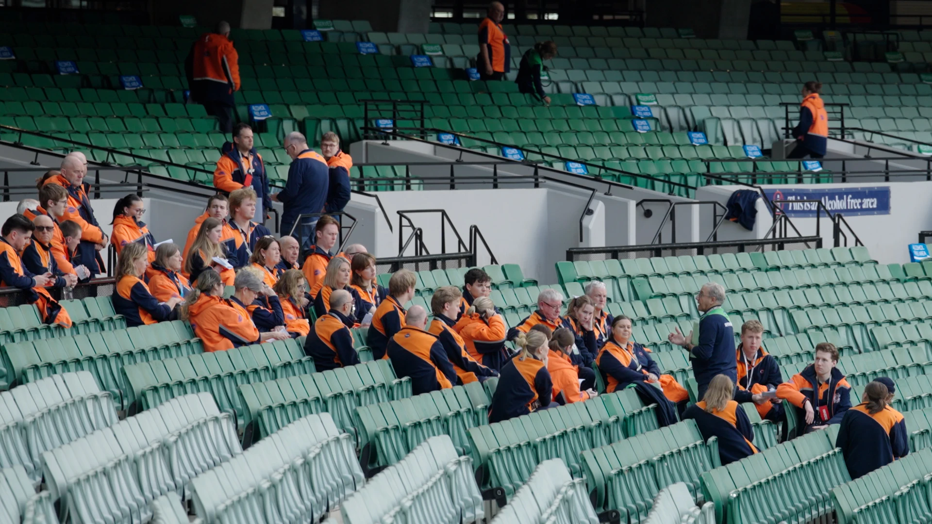 Event staff in MCC uniforms gathered in the MCG stands for a briefing