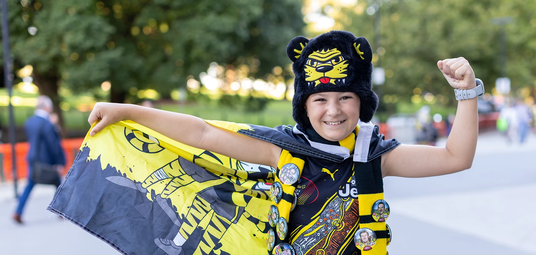 Young Richmond fan wearing a tiger hat and scarf with player badges