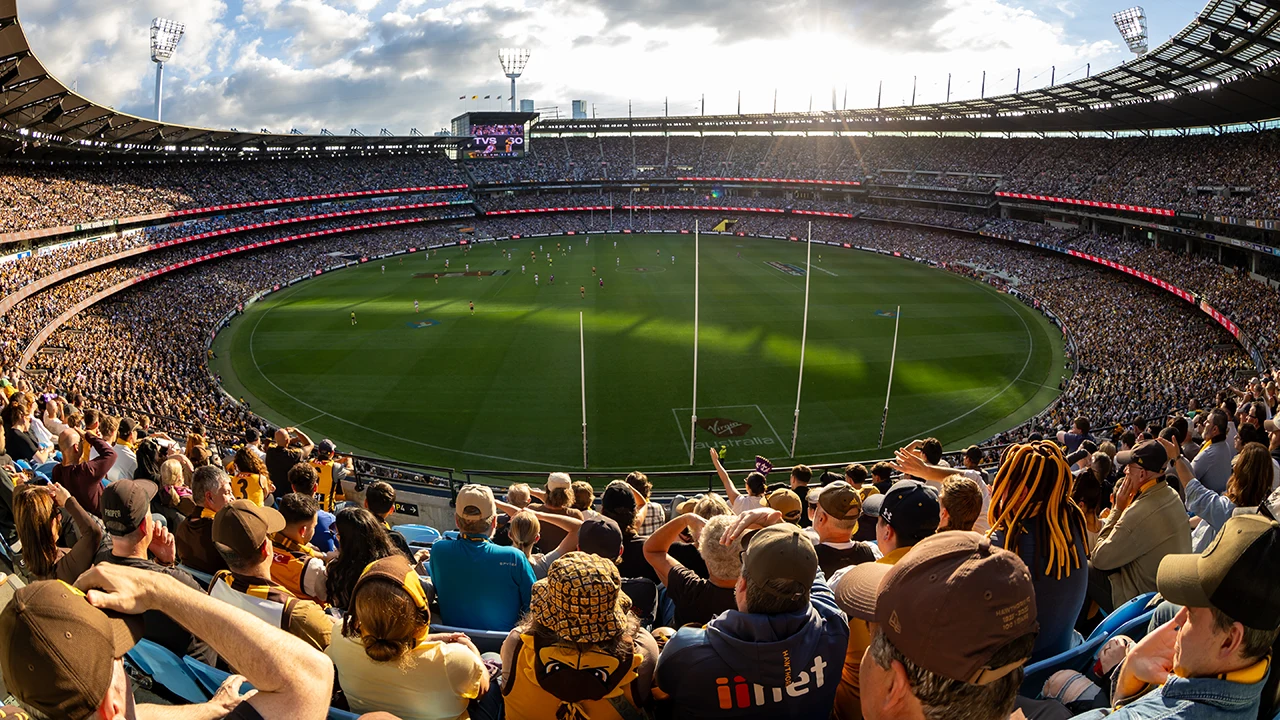Packed stands at AFL match at the MCG on sunny day