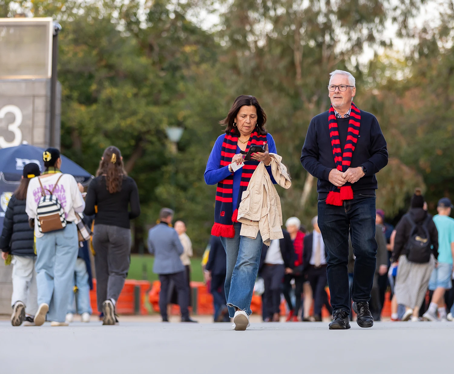 AFL fans walk along Gate 3 concourse