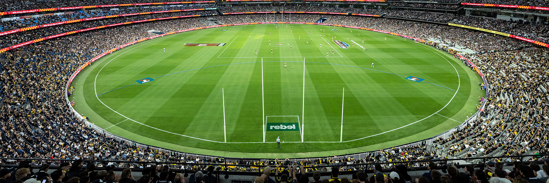A wide shot of the MCG arena lit up for an AFL match